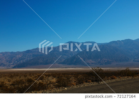 The road through Death Valley National Park, with the Panamint Mountains in the background. The road through Death Valley National Park, with the Panamint Mountains in the background. 72127164