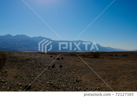 Panoramic red rocky view on Death Valley from Hell's Gate - California. Panoramic red rocky view on Death Valley from Hell's Gate - California. 72127165
