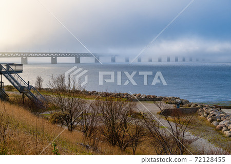 A bridge in fog. Blue ocean and mist in the background. Picture from the bridge connecting Sweden with Denmark 72128455