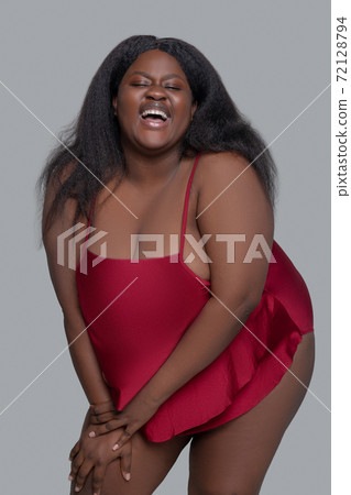 African american young woman in red underwear smiling and looking appealing 72128794