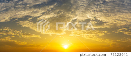 Dramatic golden sunrise and cloud sky nature panorama background Dramatic golden sunrise and cloud sky nature panorama background 72128941