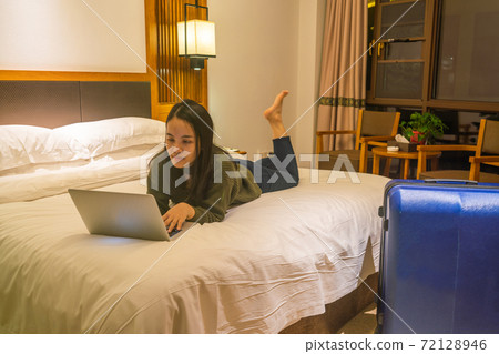 Young businesswoman working on laptop at night Young businesswoman working on laptop at night 72128946