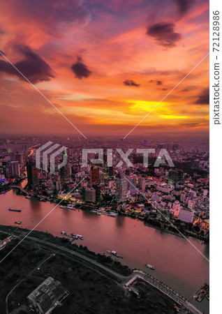 Vertical photo of cityscape and skyline under twilight orange sky Vertical photo of cityscape and skyline under twilight orange sky 72128986