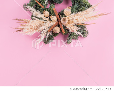 Christmas spruce wreath with dry decor on pink 72129373