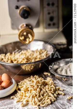 Fussili pasta dough freshly made by a machine 72129400