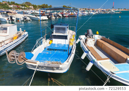 Small wooden fishing boats are moored in port Small wooden fishing boats are moored in port 72129553