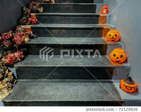 Halloween decoration with pumpkin head jack o' lantern on stairs 72129926