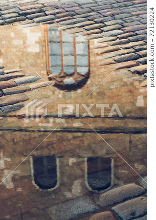Reflection of the windows of an old house in the water Reflection of the windows of an old house in the water 72130224