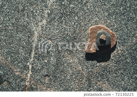 A pyramid of stones on a large stone A pyramid of stones on a large stone 72130225