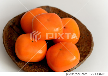 Autumn fruit persimmon white background 72133605