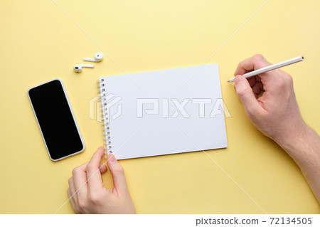 Person makes notes in notepad with copy space 72134505