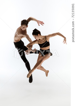 Young and graceful ballet dancers in minimal black style isolated on white studio background Young and graceful ballet dancers in minimal black style isolated on white studio background 72135091