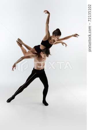 Young and graceful ballet dancers in minimal black style isolated on white studio background Young and graceful ballet dancers in minimal black style isolated on white studio background 72135102