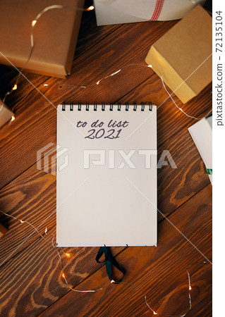 Wooden table with gift boxes and notepad. Wooden table with gift boxes and notepad. 72135104