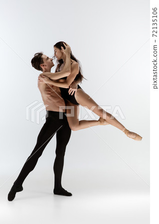 Two graceful ballet dancers man and woman in minimal black style isolated on white studio background Two graceful ballet dancers man and woman in minimal black style isolated on white studio background 72135106