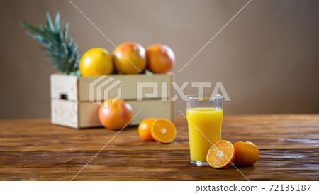 Refreshment from squeezed oranges in a tall glass. Refreshment from squeezed oranges in a tall glass. 72135187