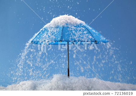 Blue umbrella on blue background with snow. Blue monday concept. 72136019