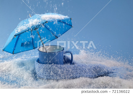 Blue umbrella and cup of coffee on blue background with snow. Blue monday concept. Blue umbrella and cup of coffee on blue background with snow. Blue monday concept. 72136022