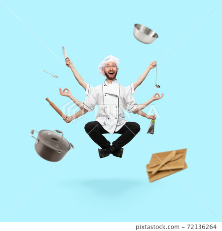 Happy handsome multi-armed cooker levitating isolated on blue studio background with equipment 72136264