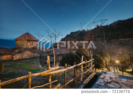 Mtskheta, Georgia. Shio-mgvime Monastery. Church Of Holy Virgin Or Theotokos In Medieval Monastic Shiomgvime Complex In Limestone Canyon Under Autumn Night Sky. Altered Starry Sky Mtskheta, Georgia. Shio-mgvime Monastery. Church Of Holy Virgin Or Theotokos In Medieval Monastic Shiomgvime Complex In Limestone Canyon Under Autumn Night Sky. Altered Starry Sky 72136778