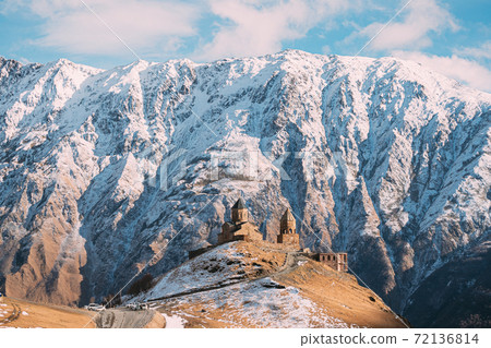 Stepantsminda, Georgia. Famous Popular Gergeti Trinity Tsminda Sameba Church In Early Winter Landscape. Beautiful Georgian Mountains Landscape 72136814