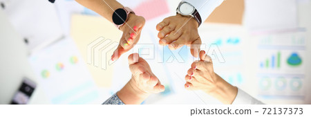 Business people over the work table are greeting hands. Business people over the work table are greeting hands. 72137373