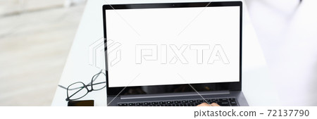 Female hands on laptop keyboard which stands on table. Female hands on laptop keyboard which stands on table. 72137790