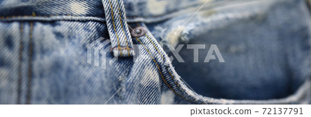 Jeans pocket made of blue frayed fabric closeup. Jeans pocket made of blue frayed fabric closeup. 72137791