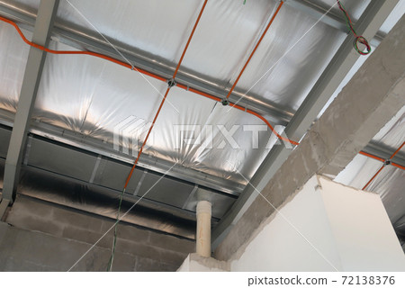 KLANG, MALAYSIA -MARCH 6, 2020: Electrical services, conduit and wiring above the ceiling. Install by electrician at the roofing trusses. KLANG, MALAYSIA -MARCH 6, 2020: Electrical services, conduit and wiring above the ceiling. Install by electrician at the roofing trusses. 72138376