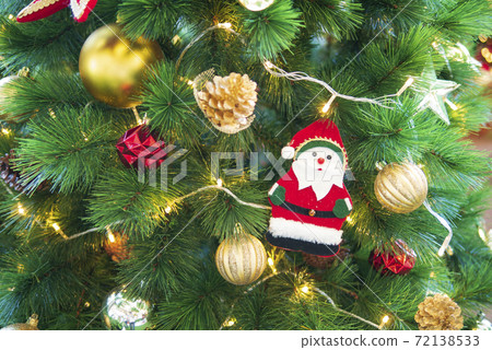 Christmas tree with golden balls and Santa Claus decoration for seasonal festival holiday Christmas tree with golden balls and Santa Claus decoration for seasonal festival holiday 72138533