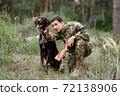Man with Rifle and Pointer Dog Hunting for Rabbit. 72138906