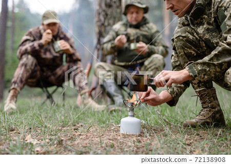 Water Boiling on Hiking Cooker Hunters Camp Fire. Water Boiling on Hiking Cooker Hunters Camp Fire. 72138908