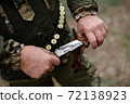 Brutal Hunting Knife in Professional Hunter Hands. 72138923