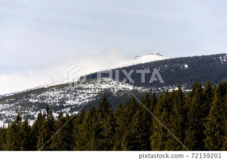 Snezka, the highest mountain in the Czech Republic, Krkonose Mountains, snowy winter day, Polish meteo observatory and Czech post office Postovna seen on top Snezka, the highest mountain in the Czech Republic, Krkonose Mountains, snowy winter day, Polish meteo observatory and Czech post office Postovna seen on top 72139201