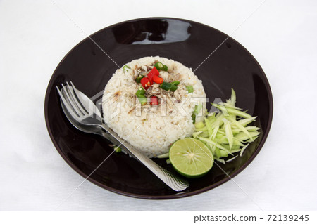 Rice Spicy blend with Mackerel and cutlery in the black dish Rice Spicy blend with Mackerel and cutlery in the black dish 72139245