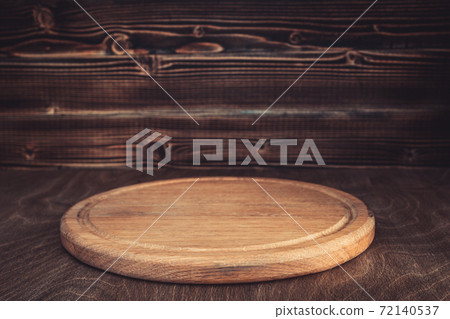 pizza cutting board at wooden table 72140537