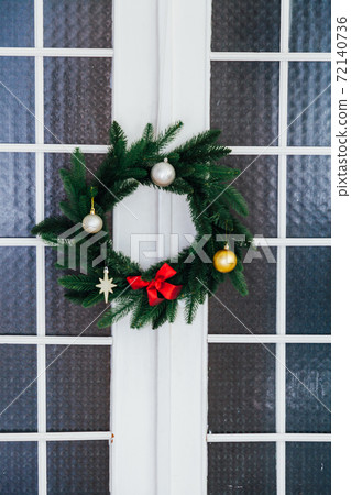 Christmas wreath on the window of the new year decor December 72140736