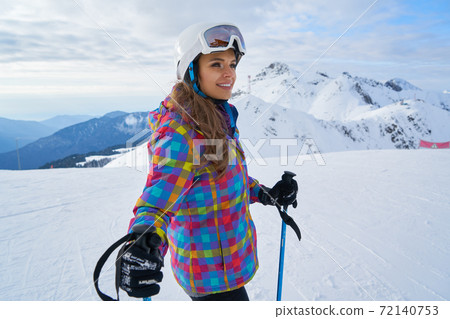 woman skier wearing white healmet with mask in snow winter mountain woman skier wearing white healmet with mask in snow winter mountain 72140753