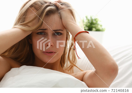 young woman is ill stay in bed have a headacke young woman is ill stay in bed have a headacke 72140816