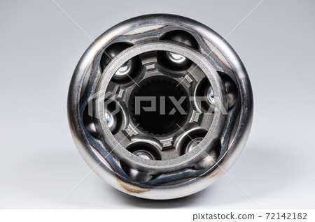 Close-up of a new CV joint on a gray background. Car suspension parts Close-up of a new CV joint on a gray background. Car suspension parts 72142182
