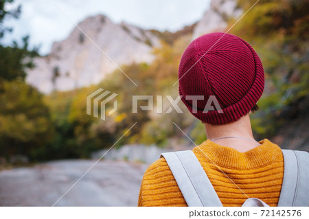 Outdoor fashion photo of young beautiful lady surrounded autumn forest in mountains 72142576