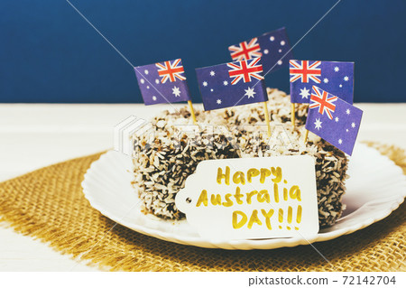 Iconic traditional Australian party food, Lamington cakes on a red, white and blue background. 72142704