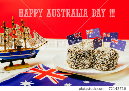 Iconic traditional Australian party food, Lamington cakes on a red, white and blue background. 72142716