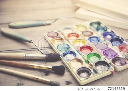 watercolor and brushes on table watercolor and brushes on table 72142859