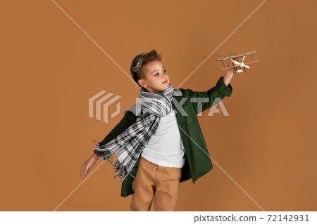 happy child boy playing with wooden toy airplane. dream happy child boy playing with wooden toy airplane. dream 72142931