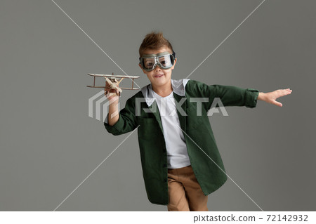 happy child boy playing with wooden toy airplane. dream happy child boy playing with wooden toy airplane. dream 72142932