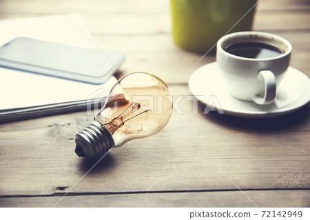 bulb, coffee, phone on table bulb, coffee, phone on table 72142949