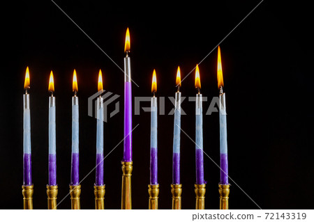 Jewish Religion holiday symbol in Menorah with burned out candles for Hanukkah 72143319