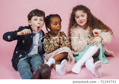 lifestyle people concept: diverse nation children playing together, boy and girl, caucasian and african american 72143733