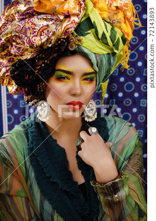 beauty bright woman with creative make up, many shawls on head like cubian, ethno look closeup beauty bright woman with creative make up, many shawls on head like cubian, ethno look closeup 72143893